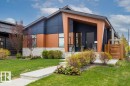 Modern architectural home featuring a multi-tone facade with dark paneling, wood-finish siding, and stone accents - 10611 146 Street Nw, Edmonton, AB  - Outdoor 