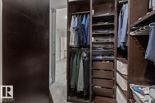 Built-in closet system featuring dark wood-finish cabinetry - 10611 146 Street Nw, Edmonton, AB - Indoor With Storage