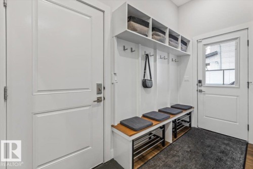 Entryway mudroom featuring built-in storage with upper shelving and integrated coat hooks - 10611 146 Street Nw, Edmonton, AB - Indoor Photo Showing Other Room