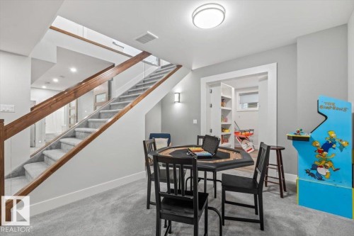 Carpeted stairs with wood-finish handrails and glass panels - 10611 146 Street Nw, Edmonton, AB - Indoor