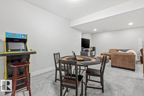 Open-concept recreation area featuring light gray walls, recessed lighting, gray carpeting, and a dropped ceiling element - 10611 146 Street Nw, Edmonton, AB - Indoor Photo Showing Dining Room