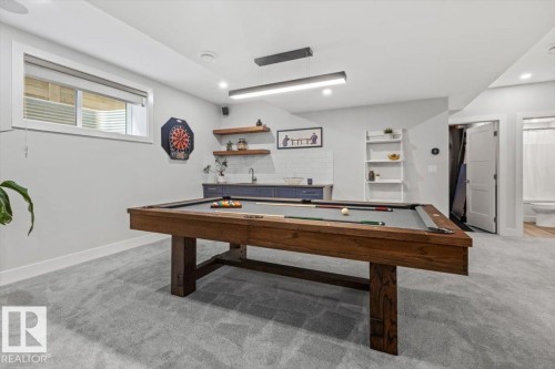 Recreation room featuring a pool table, light gray carpeting, and a built-in wet bar with wood-finish shelving - 10611 146 Street Nw, Edmonton, AB - Indoor Photo Showing Other Room