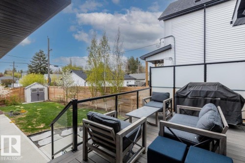 Elevated deck featuring composite decking and glass panel railings - 10611 146 Street Nw, Edmonton, AB - Outdoor With Exterior