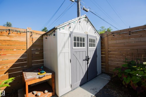 White and gray storage shed featuring double doors with windows, situated on a concrete pad - 10611 146 Street Nw, Edmonton, AB - Outdoor With Exterior