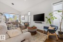 Open-concept living space featuring wood-finish flooring, a vaulted ceiling, and multiple windows - 10611 146 Street Nw, Edmonton, AB  - Indoor Photo Showing Living Room 