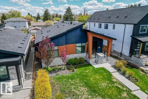 Modern architecture featuring a bold blue facade and natural wood-tone accents - 10611 146 Street Nw, Edmonton, AB - Outdoor