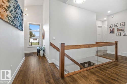 Entryway featuring wood-finish flooring, a two-story ceiling, and a prominent window - 10611 146 Street Nw, Edmonton, AB - Indoor Photo Showing Other Room