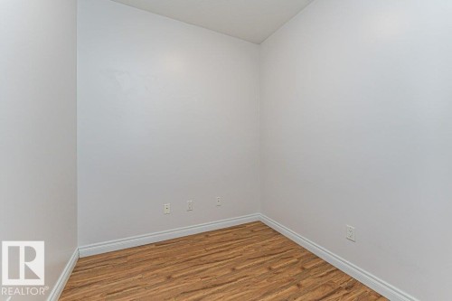 Compact room featuring light-toned walls and wood-finish flooring - 145 10121 80 Avenue, Edmonton, AB - Indoor Photo Showing Other Room