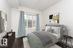 Hardwood-finish flooring features throughout this room with a large window providing ample natural light - 