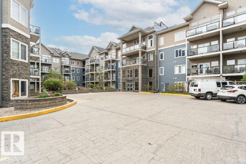 Multi-story condominium building featuring stone and siding exterior finishes - 145 10121 80 Avenue, Edmonton, AB - Outdoor With Facade