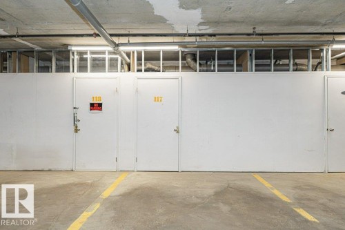 Concrete flooring with a yellow demarcation line - 145 10121 80 Avenue, Edmonton, AB - Indoor Photo Showing Garage