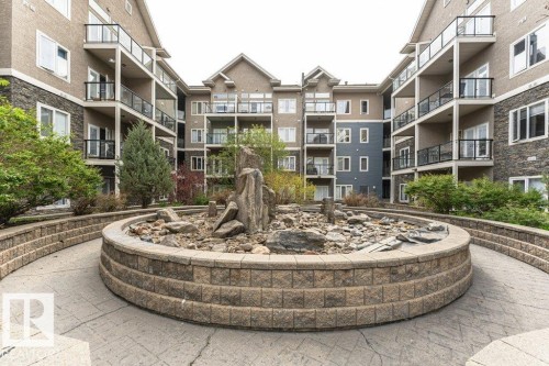 Central courtyard featuring a decorative rock garden and mature landscaping - 145 10121 80 Avenue, Edmonton, AB - Outdoor With Facade
