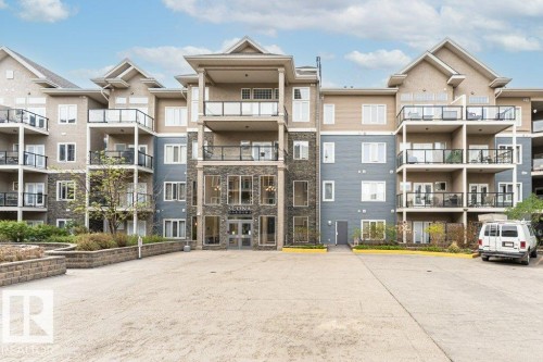 Multi-level condominium building featuring stone and siding exterior with multiple balconies - 145 10121 80 Avenue, Edmonton, AB - Outdoor With Facade