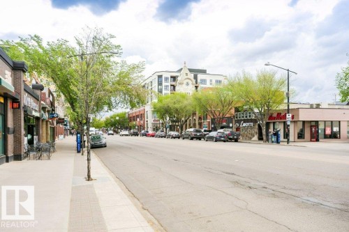 Street scene featuring a wide paved road, expansive sidewalks, and rows of established trees - 145 10121 80 Avenue, Edmonton, AB - Outdoor
