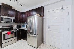 Kitchen featuring dark wood-finish cabinetry, stainless steel appliances, granite-style countertops, and white tile flooring - 