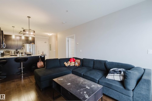 Open-concept living space featuring wood-finish flooring - 510 5151 Windermere Boulevard, Edmonton, AB - Indoor Photo Showing Living Room