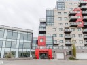Modern multi-story building featuring a red and off-white exterior - 510 5151 Windermere Boulevard, Edmonton, AB  - Outdoor With Balcony With Facade 
