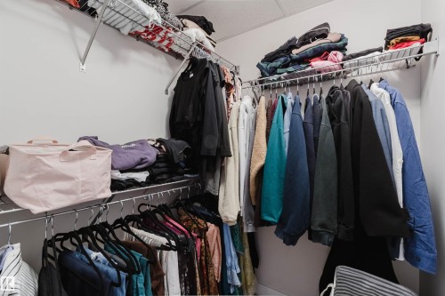 Walk-in closet featuring white walls, multi-level wire shelving, and chrome hanging rods - 510 5151 Windermere Boulevard, Edmonton, AB - Indoor With Storage