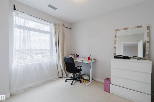 Room featuring a large window, light wall paint, and light-colored carpeting - 510 5151 Windermere Boulevard, Edmonton, AB - Indoor Photo Showing Office