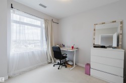 Room featuring a large window, light wall paint, and light-colored carpeting - 