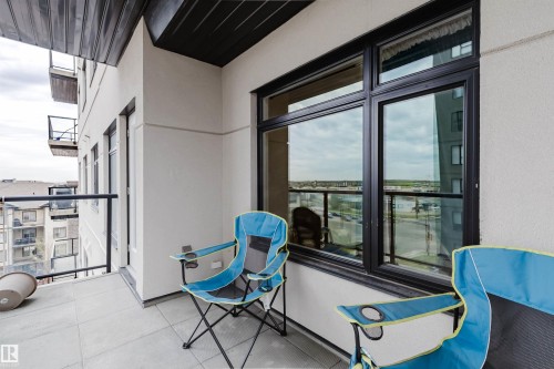 Private balcony featuring light-toned tile flooring and black-framed windows - 510 5151 Windermere Boulevard, Edmonton, AB - 