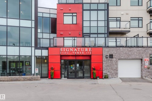 Contemporary multi-story building featuring a prominent red facade - 510 5151 Windermere Boulevard, Edmonton, AB - Outdoor