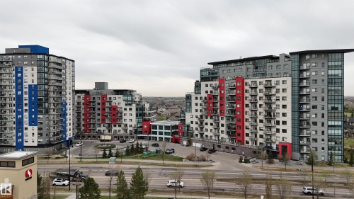 Modern multi-story building featuring a distinctive stepped facade and vibrant red accents - 510 5151 Windermere Boulevard, Edmonton, AB - Outdoor With Facade
