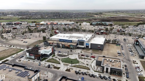 Commercial development featuring a central plaza, multiple retail buildings, and ample surface parking - 510 5151 Windermere Boulevard, Edmonton, AB - Outdoor With View