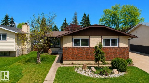 Mid-century style residence featuring a brick and stucco exterior, a brown shingle roof, and white-framed windows - 1731 51 Street, Edmonton, AB - Outdoor