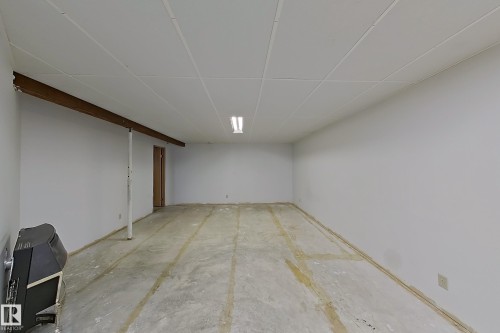 Unfinished basement space featuring white painted walls and a drop-tile ceiling - 1731 51 Street, Edmonton, AB - Indoor