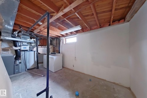 Unfinished basement featuring exposed wood ceiling joists and concrete flooring - 1731 51 Street, Edmonton, AB - Indoor