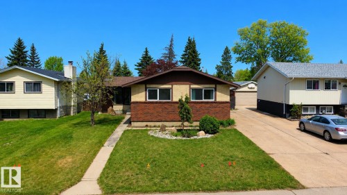 Bi-level residence featuring a brick facade, stucco exterior, and a concrete pathway - 1731 51 Street, Edmonton, AB - Outdoor With Facade