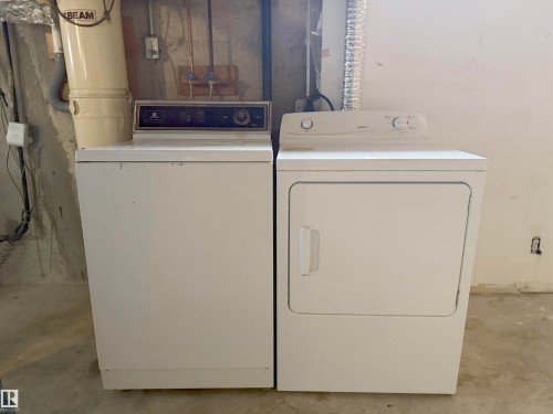 Dedicated laundry area with a white washing machine and dryer set - 1731 51 Street, Edmonton, AB - Indoor Photo Showing Laundry Room
