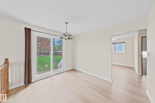 Dining area featuring light wood-finish flooring and a glass pendant light fixture - 1731 51 Street, Edmonton, AB - Indoor Photo Showing Other Room