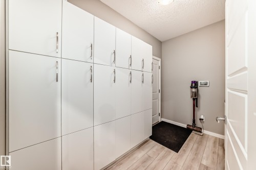 Full-height white cabinetry with brushed steel pulls - 38 Prospect Place, Spruce Grove, AB - Indoor Photo Showing Other Room