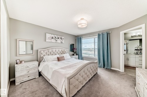 Carpeted room with light grey walls and a large window - 38 Prospect Place, Spruce Grove, AB - Indoor Photo Showing Bedroom