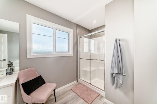 Walk-in shower with clear glass enclosure and integrated seating - 38 Prospect Place, Spruce Grove, AB - Indoor Photo Showing Bathroom