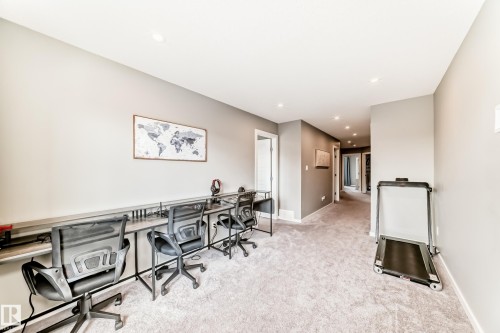 Dedicated workspace featuring a built-in desk spanning the length of the wall, complete with multiple seating areas - 38 Prospect Place, Spruce Grove, AB - Indoor