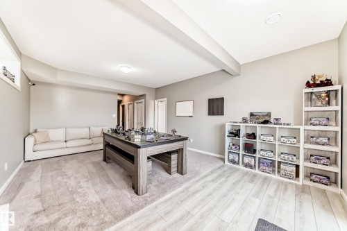 Spacious room featuring light gray walls and a combination of light wood-finish flooring and carpeting - 38 Prospect Place, Spruce Grove, AB - Indoor
