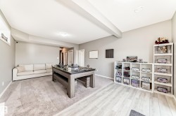 Spacious room featuring light gray walls and a combination of light wood-finish flooring and carpeting - 