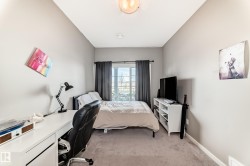 Carpeted room featuring a window with dark drapery, white baseboards, and a ceiling light fixture - 