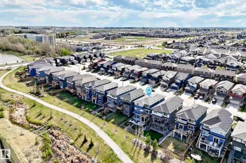 Townhome situated within a residential development, featuring a multi-level structure with a dark roof - 38 Prospect Place, Spruce Grove, AB - Outdoor With View
