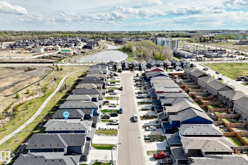 Residential street featuring a row of single-family homes with gray shingle roofs, individual driveways, and front yards - 38 Prospect Place, Spruce Grove, AB - Outdoor With View