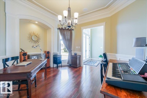 Formal room featuring rich wood-finish flooring, intricate crown molding, and wainscoting - 2413 Tegler Green, Edmonton, AB - Indoor Photo Showing Office