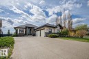Contemporary stucco exterior with dark trim accents and stone detailing - 2413 Tegler Green, Edmonton, AB  - Outdoor With Facade 