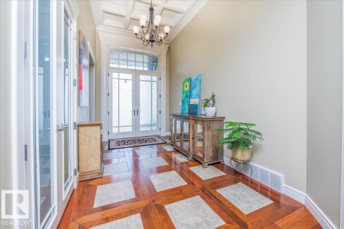 Entryway featuring a coffered ceiling and an ornate chandelier - 2413 Tegler Green, Edmonton, AB - Indoor Photo Showing Other Room