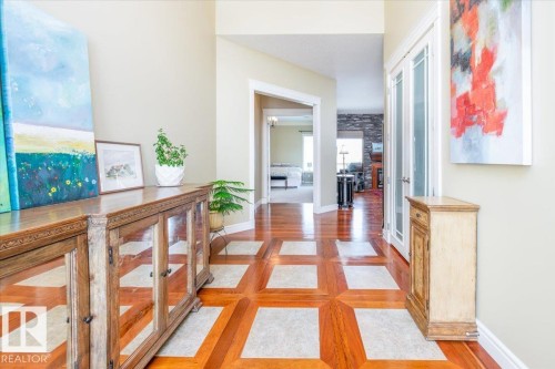 Entryway featuring wood-finish flooring with light-toned inset squares - 2413 Tegler Green, Edmonton, AB - Indoor Photo Showing Other Room
