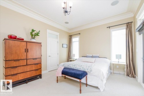 Light-filled bedroom featuring crown molding, neutral wall tones, and recessed ceiling speakers - 2413 Tegler Green, Edmonton, AB - Indoor Photo Showing Bedroom