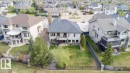 Rear exterior featuring a multi-level deck, a private balcony, and a walk-out patio - 2413 Tegler Green, Edmonton, AB  - Outdoor 