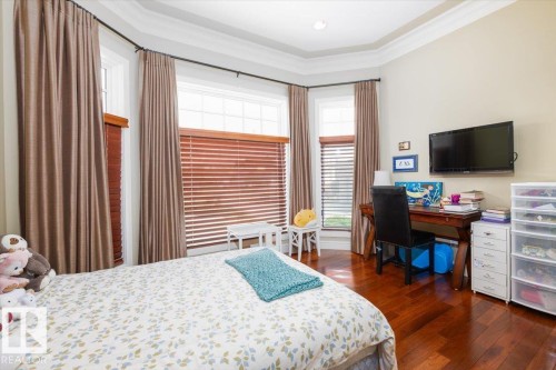 Bay window with wood-finish blinds and neutral drapes - 2413 Tegler Green, Edmonton, AB - Indoor Photo Showing Bedroom